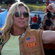 Rep. Marjorie Taylor Greene flexes during a Bikers for Trump campaign event held at the Crazy Acres Bar & Grill on May 20, 2022 in Plainville, Georgia